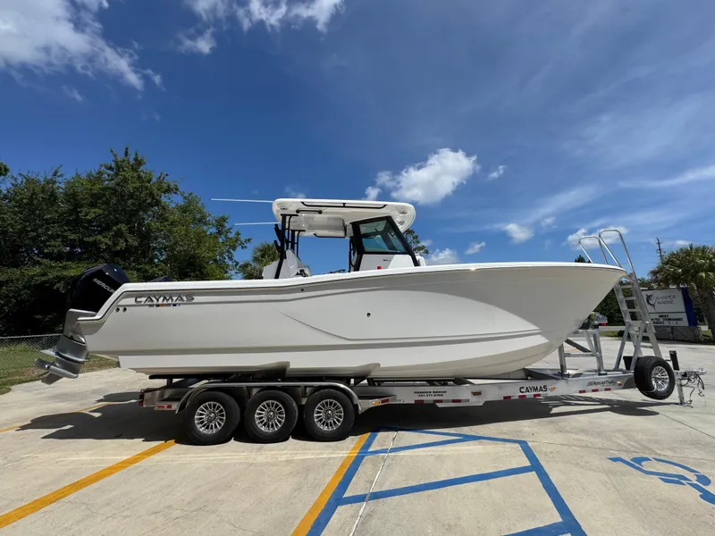 Slide: The Image of 2026 Caymas 30 CT boat on trailer under clear blue sky. - 10
