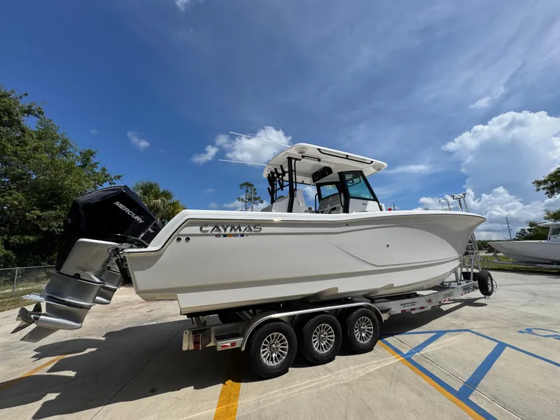 Slide: The Image of 2026 Caymas 30 CT boat on trailer under clear blue sky. - 11