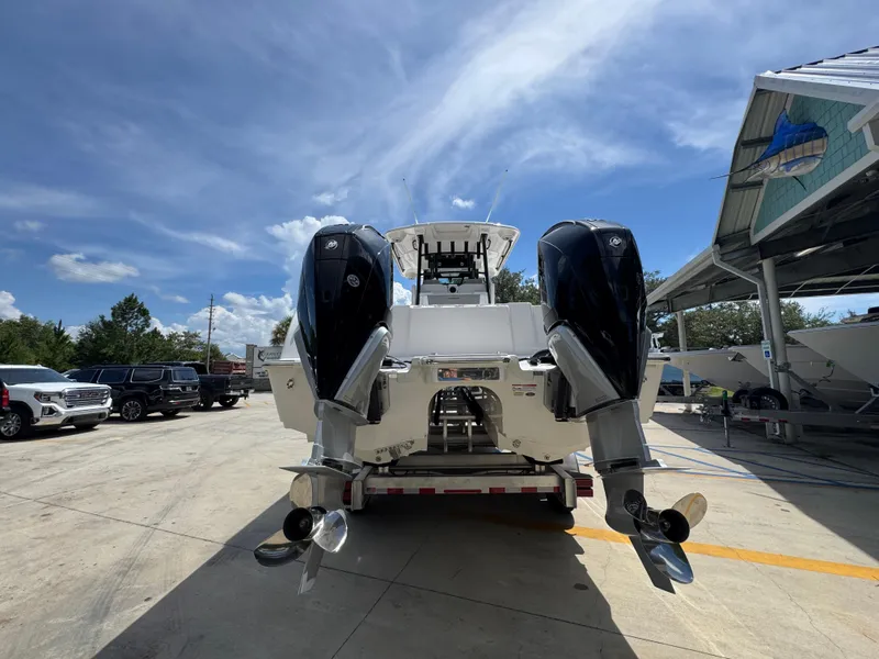 Slide: The Image of 2026 Caymas 30 CT boat with dual outboard motors in a sunny marina setting. - 14