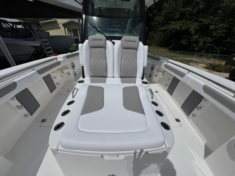Slide: The Image of 2026 Caymas 30 CT boat interior with cushioned seating and cup holders. - 21