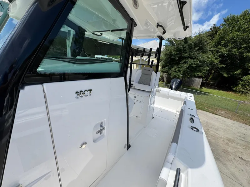 Slide: The Image of 2026 Caymas 30 CT boat, sleek white design, spacious deck, modern features, outdoor setting. - 24
