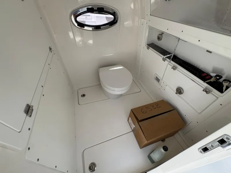 Slide: The Image of 2026 Caymas 30 CT boat interior with toilet and storage compartment. - 26