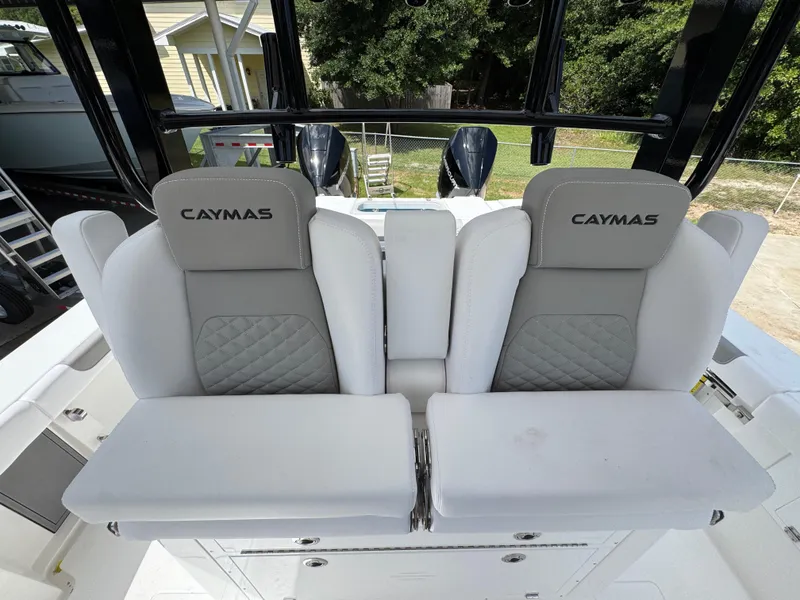 Slide: The Image of 2026 Caymas 30 CT boat seats with gray and white upholstery, featuring Caymas branding. - 30