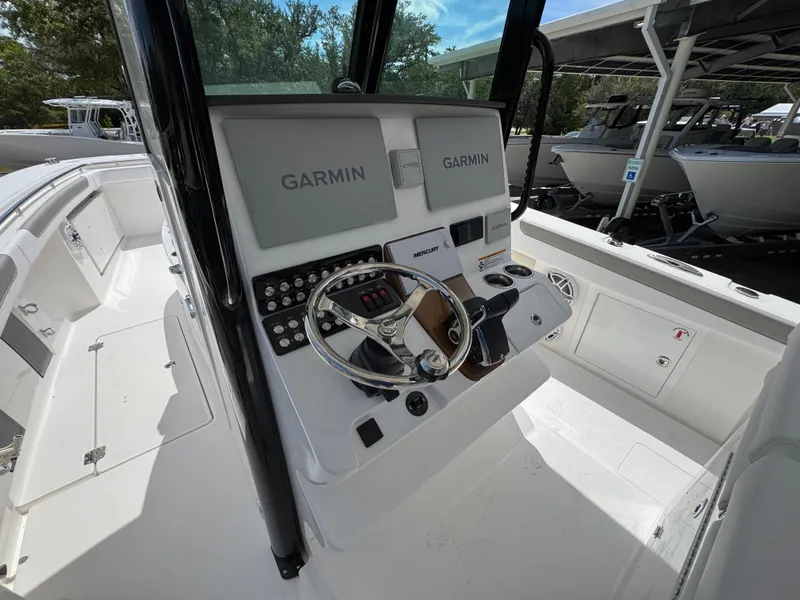 Slide: The Image of 2026 Caymas 30 CT boat cockpit with Garmin navigation system and steering wheel. - 31
