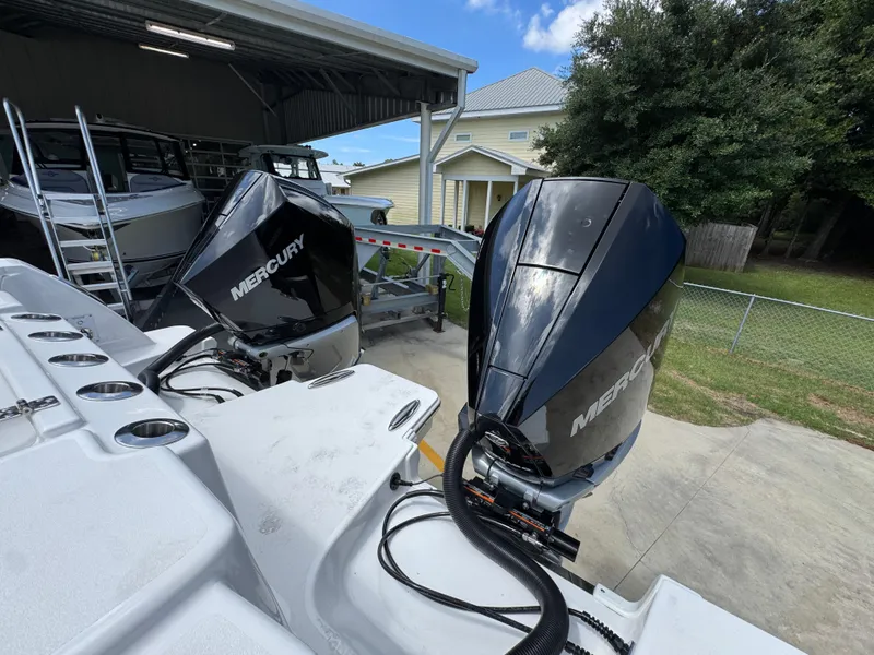 Slide: The Image of 2026 Caymas 30 CT boat with dual Mercury outboard engines in a storage area. - 40