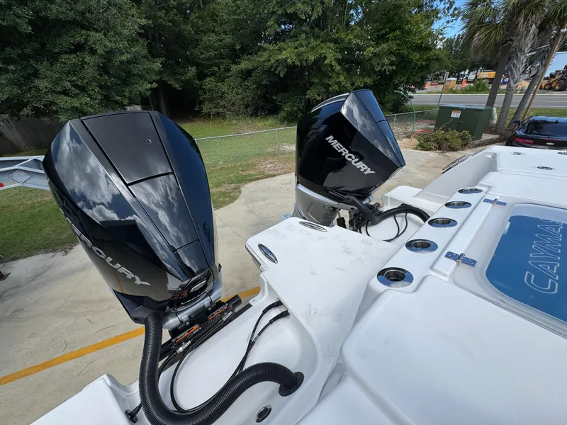 Slide: The Image of Twin Mercury outboard engines on a 2026 Caymas 30 CT boat, parked outdoors. - 41