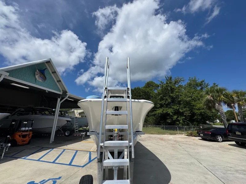 Slide: The Image of 2026 Caymas 30 CT boat on trailer under blue sky with clouds. - 7