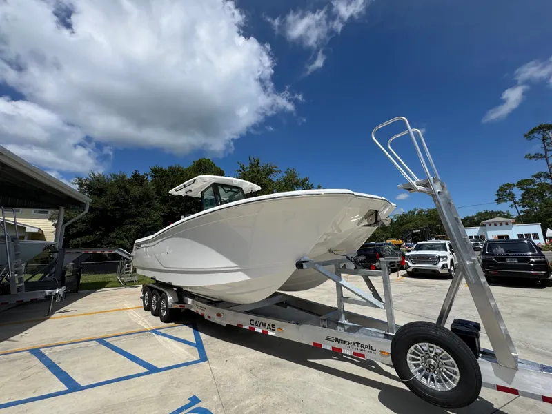 Slide: The Image of 2026 Caymas 30 CT boat on trailer under clear blue sky. - 8