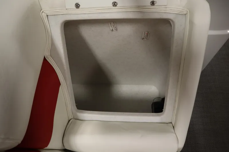 Slide: The Image of Open storage compartment in a 2014 JC 22 Limited boat seat. - 17