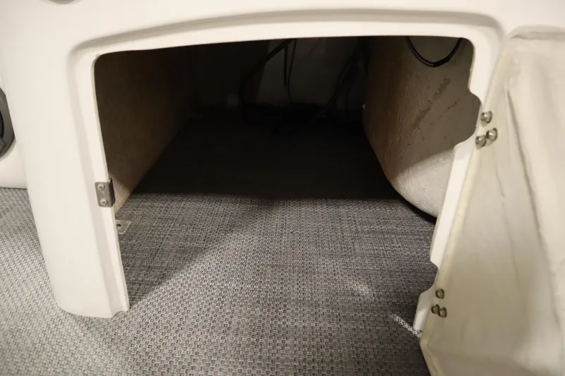 Slide: The Image of Open storage compartment in a 2014 JC 22 Limited boat, featuring carpeted interior. - 22