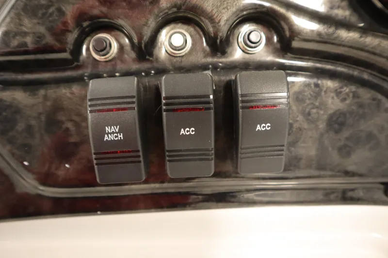 Slide: The Image of Control panel with switches labeled "NAV ANCH" and "ACC" on a 2014 JC 22 Limited. - 26