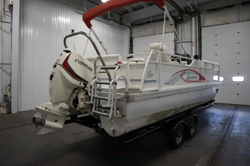 Slide: The Image of 2014 JC 22 Limited pontoon boat with Evinrude motor in indoor storage. - 4