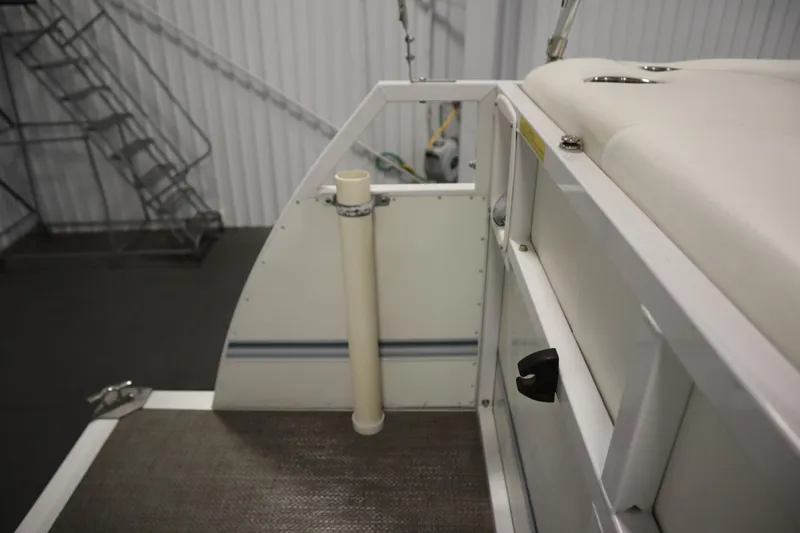 Slide: The Image of 2014 JC 22 Limited boat interior with seating and railing in a storage facility. - 46
