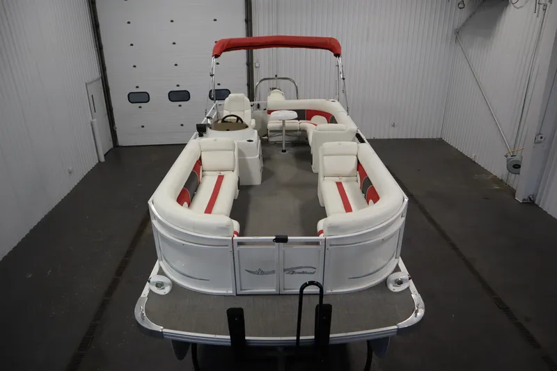 Slide: The Image of 2014 JC 22 Limited pontoon boat with red canopy in a garage. - 8