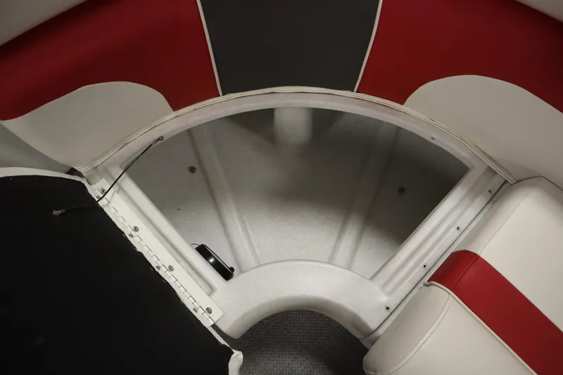 Slide: The Image of Interior view of a 2014 JC 22 Limited boat, featuring red and white seating. - 19