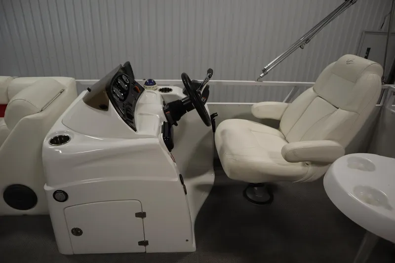 Slide: The Image of 2014 JC 22 Limited boat interior with steering console and plush captain's chair. - 21