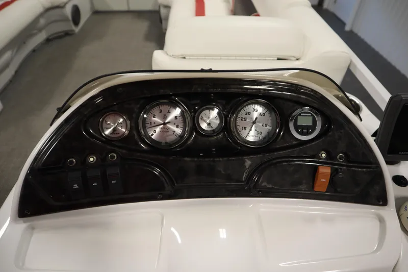 Slide: The Image of Dashboard of a 2014 JC 22 Limited boat with gauges and controls. - 25
