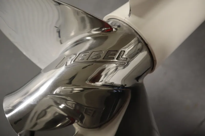 Slide: The Image of Close-up of a shiny metal propeller with "Rebel" engraving, JC 22 Limited 2014 model. - 49