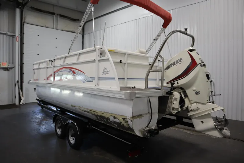 Slide: The Image of 2014 JC 22 Limited pontoon boat with Evinrude outboard motor in a garage. - 6