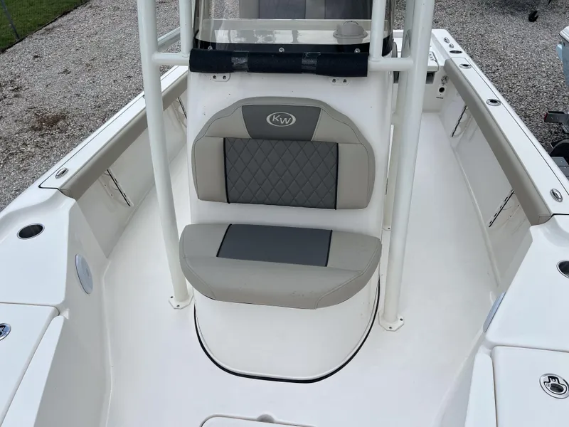 Slide: The Image of 2026 Key West 230 Bay Reef boat interior with cushioned seating and white deck. - 12
