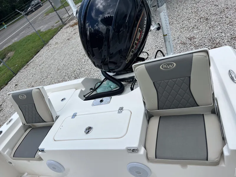 Slide: The Image of 2026 Key West 230 Bay Reef boat seats and Yamaha engine, parked on gravel. - 14