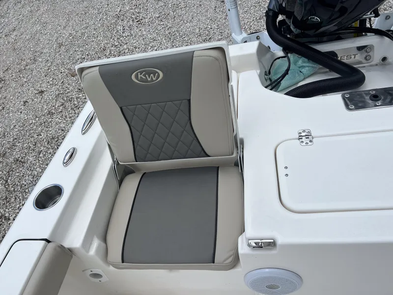 Slide: The Image of 2026 Key West 230 Bay Reef boat seat with gray and beige upholstery. - 16