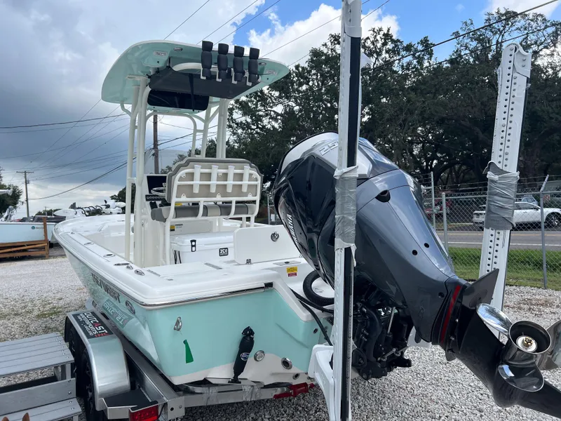 Slide: The Image of 2026 Key West 230 Bay Reef boat on trailer, featuring powerful outboard motor. - 6