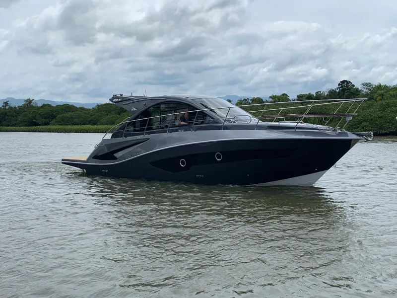 The Image of 2022 Evolve 400HT yacht cruising on a calm river under cloudy skies. - 0