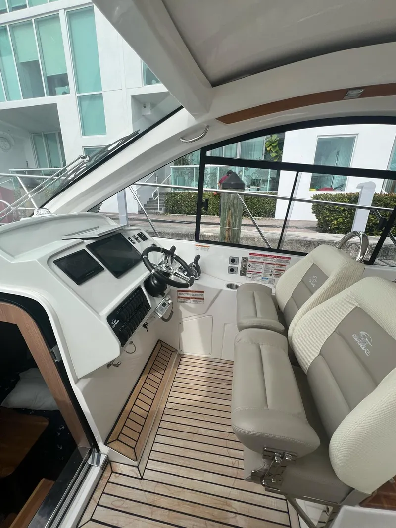 Slide: The Image of Interior of a 2022 Evolve 400HT yacht with modern helm and seating. - 17