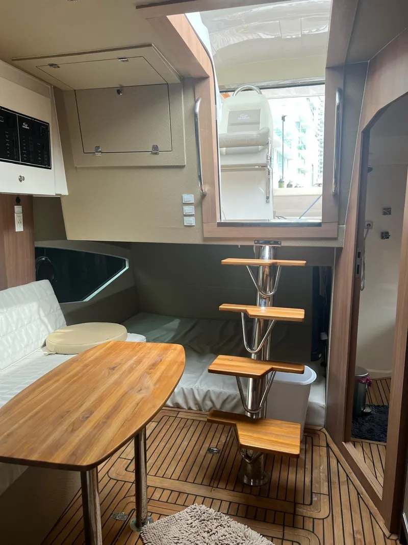 Slide: The Image of Interior of 2022 Evolve 400HT yacht with wooden table, modern staircase, and cozy seating area. - 19