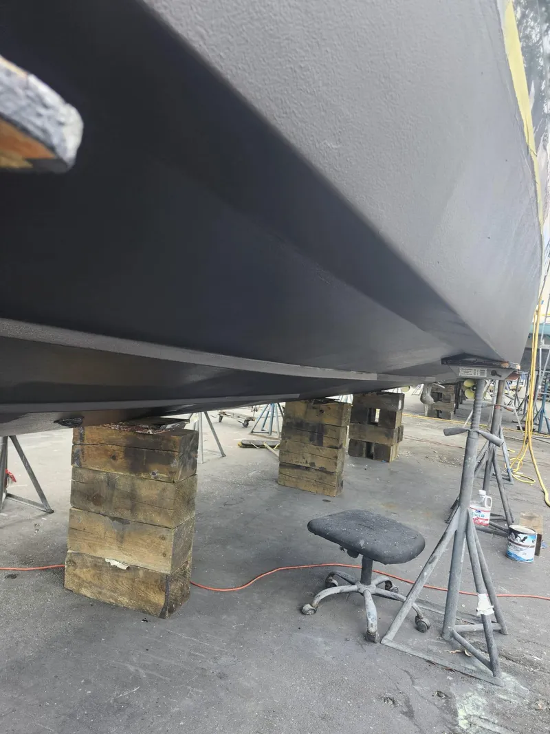 Slide: The Image of 2022 Evolve 400HT boat hull on blocks in a maintenance area. - 23