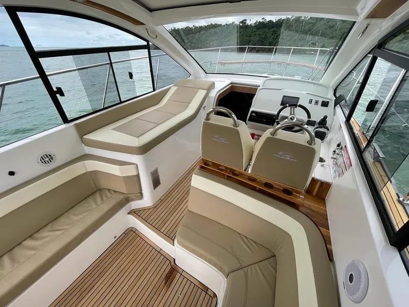 Slide: The Image of Interior of 2022 Evolve 400HT yacht with beige seating and modern helm. - 5
