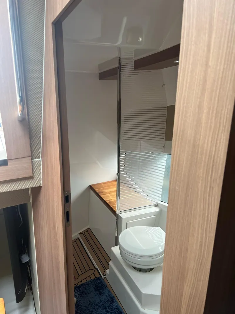 Slide: The Image of Modern bathroom interior of 2022 Evolve 400HT yacht, featuring sleek design and wooden accents. - 16
