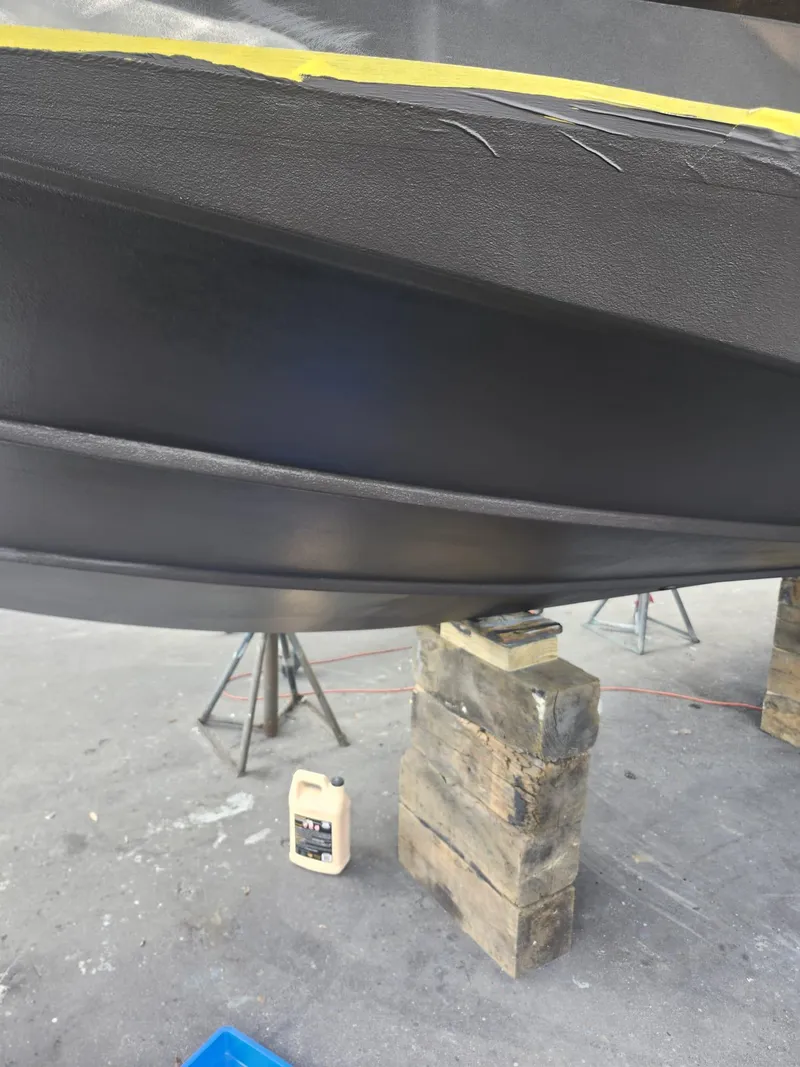 Slide: The Image of 2022 Evolve 400HT boat hull on stands, undergoing maintenance with tools nearby. - 22