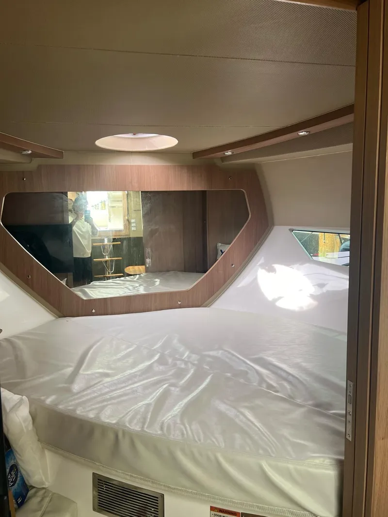 Slide: The Image of Interior of 2022 Evolve 400HT boat cabin with round bed and mirror. - 25