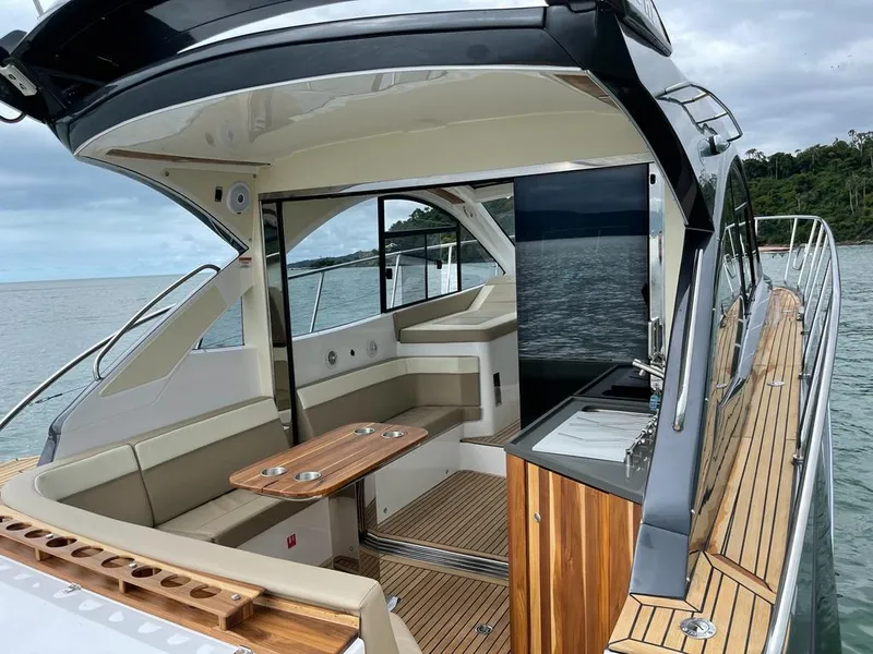 Slide: The Image of Luxury Evolve 400HT yacht interior, 2022 model, featuring elegant seating and wooden accents. - 3