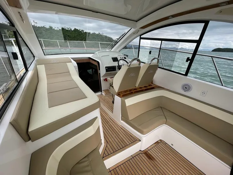 Slide: The Image of Luxurious interior of 2022 Evolve 400HT yacht with beige seating and wood flooring. - 4