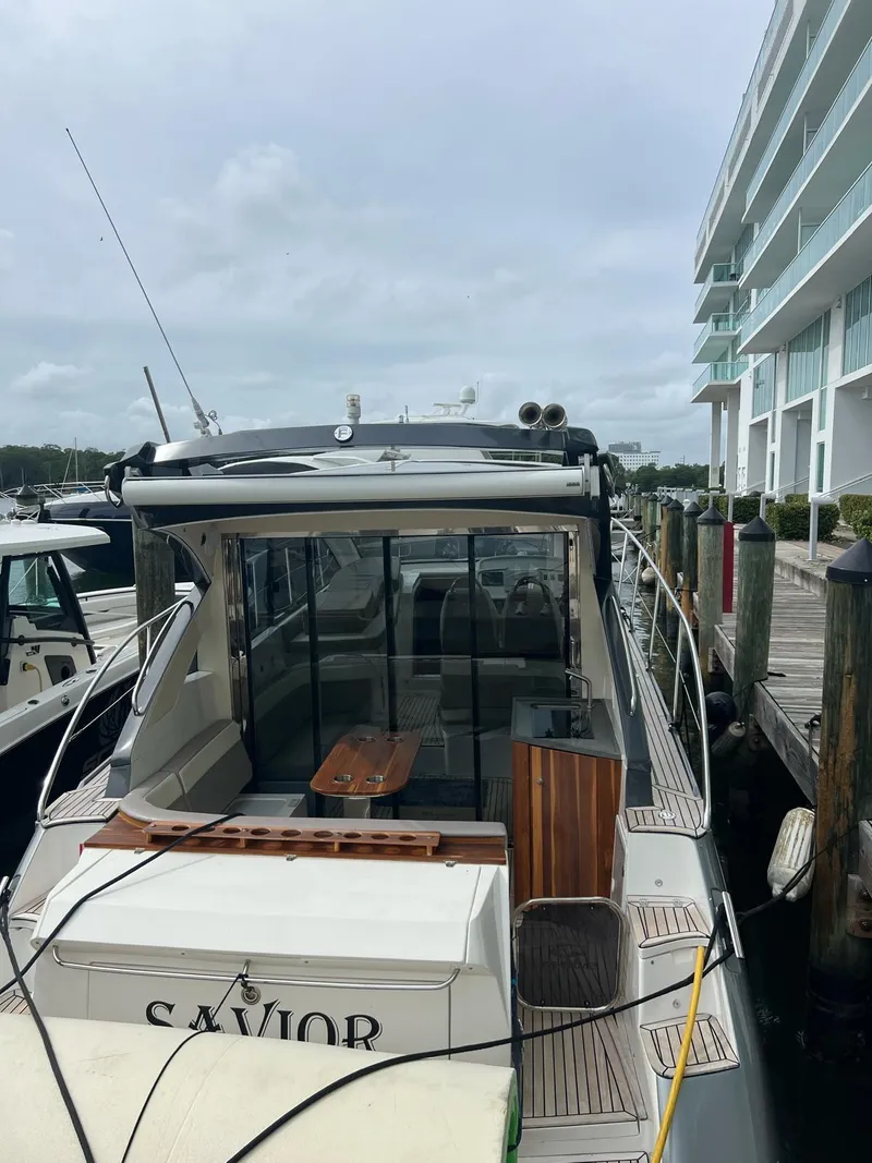 Slide: The Image of Evolve 400HT 2022 yacht docked at marina, modern design, overcast sky. - 9