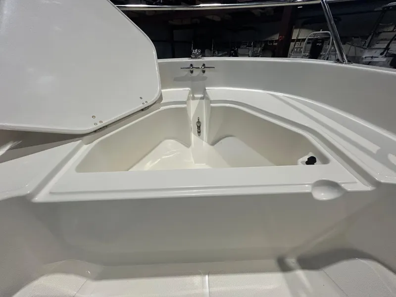 Slide: The Image of 2026 Boston Whaler 130 Super Sport boat interior storage compartment. - 13