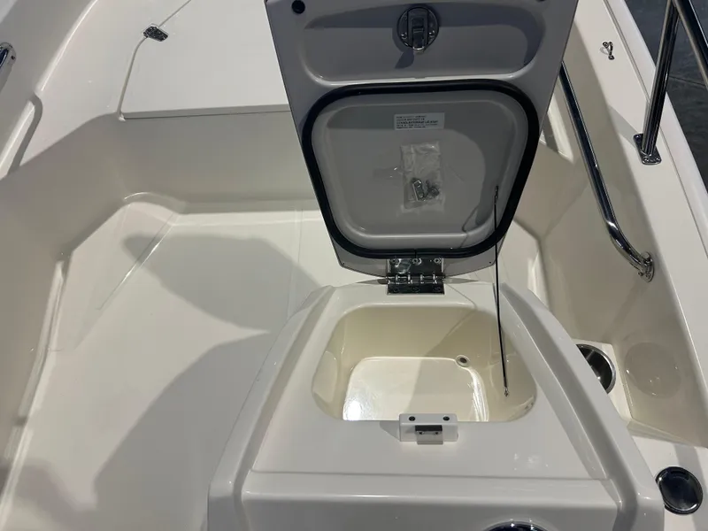 Slide: The Image of 2026 Boston Whaler 130 Super Sport interior storage compartment with open lid. - 14