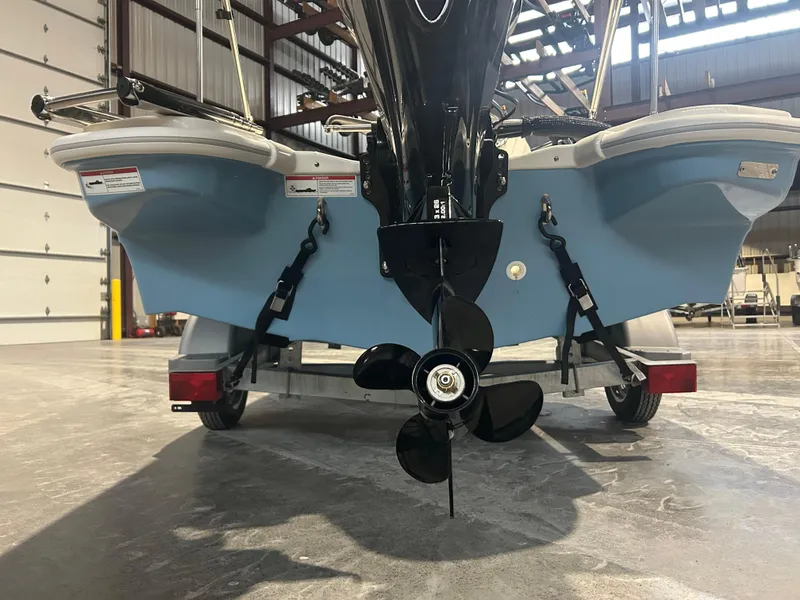 Slide: The Image of 2026 Boston Whaler 130 Super Sport boat on trailer, rear view in warehouse. - 6