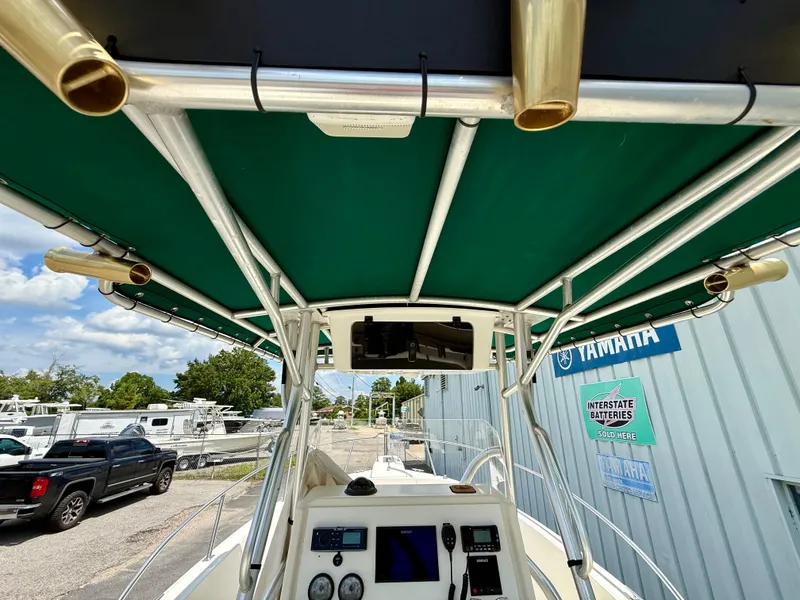 Slide: The Image of 1997 Pursuit 2470 Center Console boat interior with green canopy and control panel. - 12
