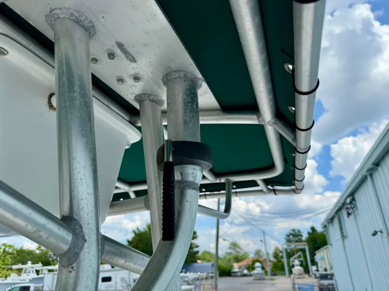 Slide: The Image of Close-up of 1997 Pursuit 2470 Center Console boat's metal framework under blue sky. - 13