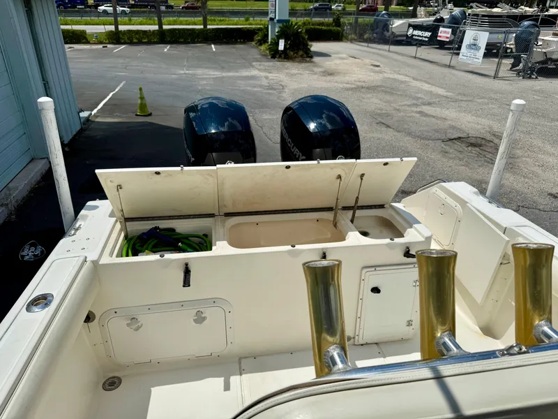 Slide: The Image of 1997 Pursuit 2470 Center Console boat with open storage compartments and dual outboard motors. - 16