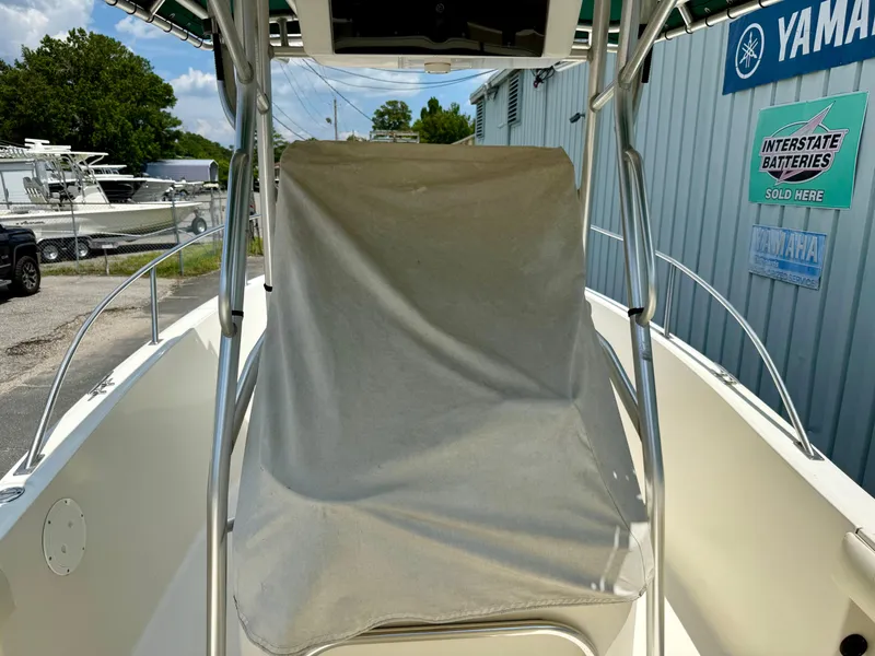 Slide: The Image of 1997 Pursuit 2470 Center Console boat with covered console, docked near Yamaha service signs. - 5
