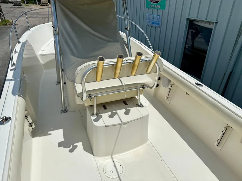 Slide: The Image of 1997 Pursuit 2470 Center Console boat interior with rod holders and seating. - 6