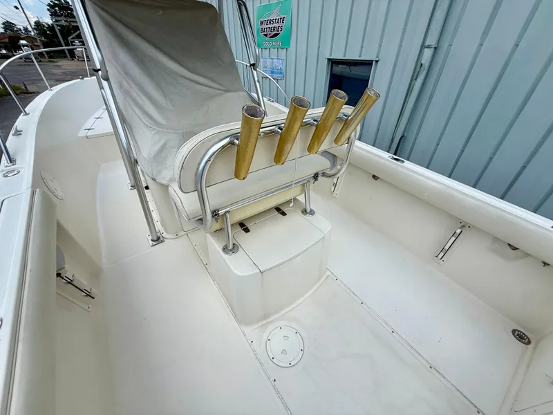 Slide: The Image of 1997 Pursuit 2470 Center Console boat interior with covered seating and rod holders. - 7