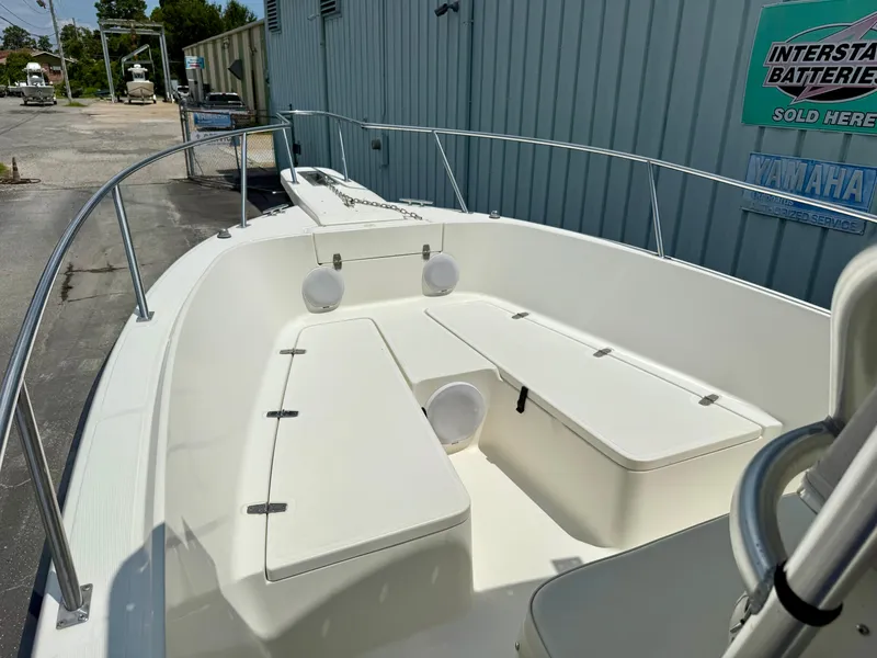 Slide: The Image of 1997 Pursuit 2470 Center Console boat, white deck, docked near a building. - 8
