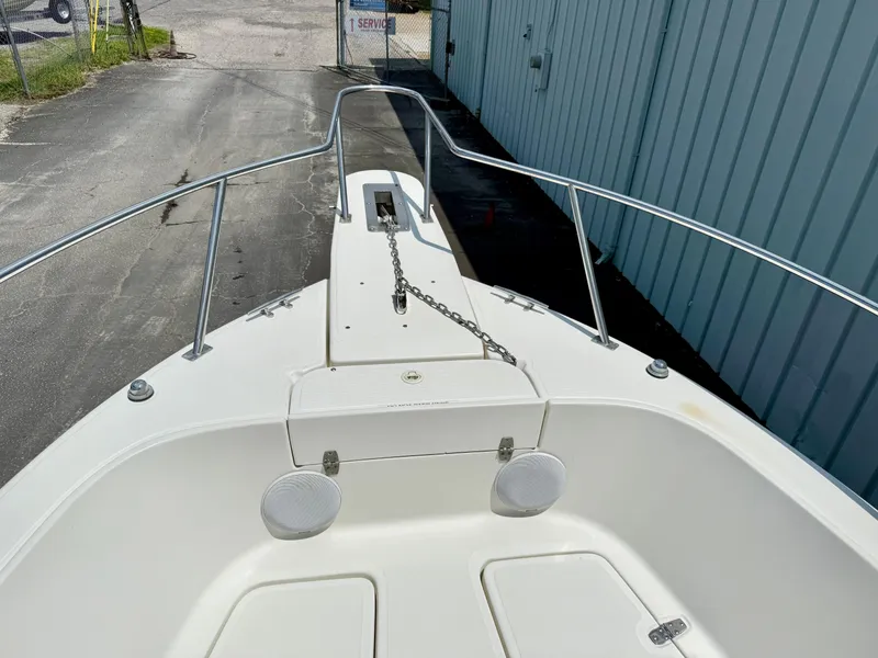 Slide: The Image of 1997 Pursuit 2470 Center Console boat deck with anchor chain and speakers. - 9