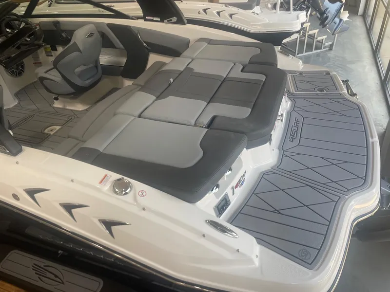 Slide: The Image of 2026 Chaparral GT Surf 1 boat interior with gray seating and deck. - 3